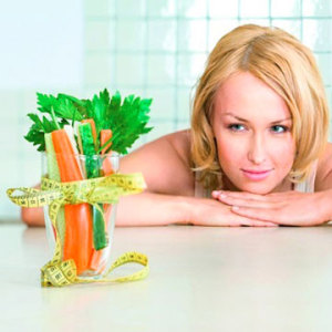Девушка смотрит на стакан с овощами