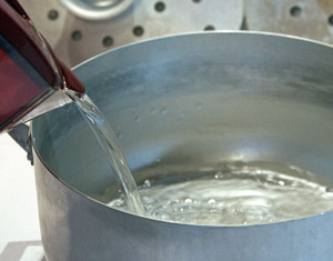 Наливание воды в кастрюлю