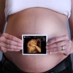 Беременная девушка держит 3д изображение