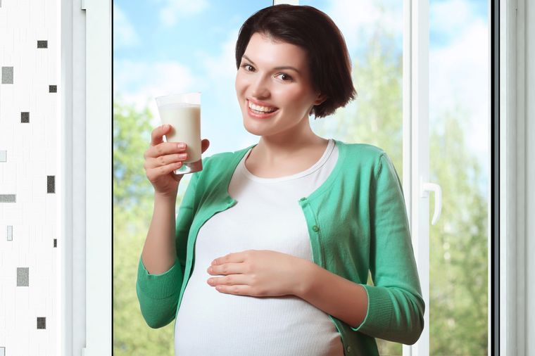 беременная женщина пьет кефир