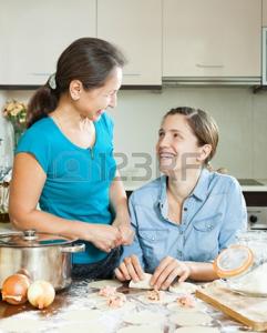 women cooking meat dumplings together at home